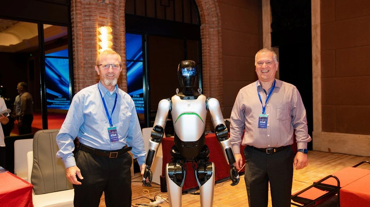 Evonik delegates pose with a humanoid robot at the workshop